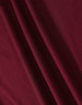 A close-up of a textured fabric in a rich burgundy colour, showcasing its drape and weave.