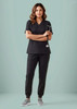 A black women's scrub top featuring a V-neck design, paired with matching black scrub pants and sneakers.