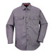 A grey work shirt with two chest pockets and long sleeves, featuring a logo on one sleeve.