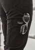 A close-up of black cargo pants with a logo and clear sunglasses tucked into the pocket.
