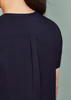 A women's rose tunic scrub top, featuring a sleek design with a pleat detail at the back. The fabric is dark navy.