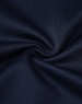 A close-up of textured navy fabric, showcasing the sustainable poly/cotton blend used in kids' polo shirts.