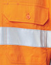 An orange safety shirt featuring a reflective silver tape and a pocket with an orange button.