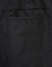 A close-up of black cotton stretch ripstop work pants, featuring a back pocket design and fabric texture.