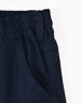 Unisex navy cotton stretch drill cuffed work pants with an elastic waistband and side pockets. Features a logo.