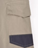 A close-up of unisex cotton stretch drill cuffed work pants in light khaki with a dark navy pocket detailing.