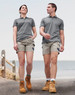 A pair of unisex cotton stretch drill short work shorts in light grey, worn by a male and female model.
