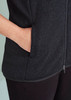 A black vest featuring a zip front and side pockets, with a smooth fabric texture. It has a branding logo.