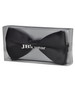A black bow tie packaged in a clear box, featuring a logo on the front.