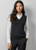 A black women's V-neck knit vest worn over a white shirt, featuring a fitted design and no visible branding.