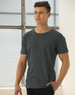 A model wearing a blue heather short-sleeve t-shirt with a relaxed fit, featuring a visible logo.