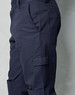 Men's cargo pants in navy blue, featuring knee pads and multiple pockets, with a sleek, fitted design.