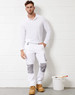 White unisex cargo work pants with grey accents, paired with a long-sleeve white top and work boots, standing next to a paint bucket.