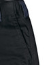 A close-up of black unisex utility stretch cargo work pants featuring a waistband and side pocket detailing.