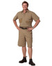 A man stands confidently wearing khaki heavy duck weave work shorts with pockets, paired with black footwear.