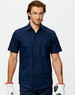 A navy cotton drill short sleeve work shirt with two chest pockets, worn by a model wearing safety glasses and gloves.