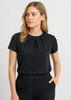A black short sleeve women's top features pleats at the neckline, paired with tailored trousers. The image includes a logo.