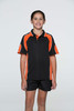 A child wears a black polo shirt with orange accents, featuring a logo on the chest.