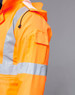 An orange safety jacket featuring reflective silver strips, with a pocket on the sleeve and a hood.