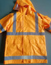 A high-visibility yellow safety jacket featuring reflective strips and a hood, with multiple pockets.