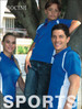 A blue short sleeve polo shirt with white contrast panels. The shirt features a logo and is modeled by a woman and a boy.