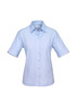 A light blue short sleeve button-up shirt for women with rolled sleeves and a subtle logo.