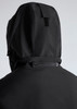 A black rain jacket featuring a hood and a rear zipper detail. The jacket includes branding.