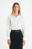 A white ladies long sleeve button-up shirt, styled with a black skirt, featuring a logo on the garment.