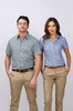 A short sleeve button-up shirt in blue and white check pattern worn by a man and woman, paired with beige trousers.