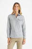 A light grey button-up shirt with two front pockets, designed for women, featured on a model.