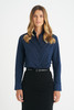 A ladies' long sleeve button-up shirt in navy blue, featuring a collar and button front, styled with a black belt.