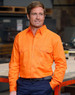 A bright orange men's long-sleeve drill shirt with two front pockets and a logo, set against an industrial background.