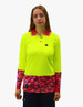 A long-sleeve polo shirt in bright yellow with a pink camo pattern on the sleeves and hem, featuring a logo.
