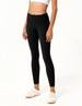 Black ladies' leggings featuring a high waistband and fitted design, paired with white sneakers.