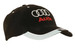 A black cap with reflective trim, featuring a logo on the front and a tab on the peak.