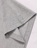 A close-up of a grey long-sleeve cotton tee shirt, featuring a stitched hem and smooth fabric texture.