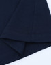 A navy blue long-sleeve cotton tee shirt featuring a hemmed finish and a logo on the sleeve.