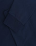 A navy blue long-sleeve T-shirt with folded sleeves and a subtle logo.