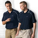 Two men wearing navy blue Dri Gear Eyelet Polo shirts with white detailing and logos, standing against a light background.