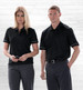 A black Dri Gear Matrix polo shirt for men and women, featuring contrasting accents and a logo.