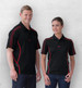 A black polo shirt featuring red detailing, displayed on a male and a female model. The shirt has a logo.