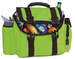 A green lunch bag filled with various snacks, fruits, and a beverage, featuring a handle and adjustable straps.