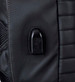 A close-up of a black backpack featuring a sleek, textured design and a small logo on the surface.