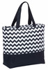 A black and white striped cooler tote with a zigzag pattern and a black zippered bottom compartment.