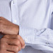 A blue and white check button-up shirt featuring a cuff and button detail.