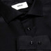 A close-up of a black button-up shirt featuring a collar and glossy buttons. The shirt has a logo label.