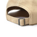 A beige cap with a buckle fastening, showcasing a textured fabric and a curved brim.