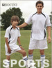 A pair of unisex white sports shorts worn by a male adult and a young boy, featuring black accents and a logo.