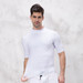 A man wears a white short-sleeved rashie, showcasing a smooth, tight fit and a simple design.