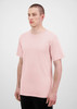 A light pink men's short sleeve t-shirt displayed on a model, featuring a plain design and a logo.